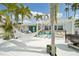 Expansive backyard patio with hammock, outdoor seating, grill, and lush tropical landscaping, perfect for outdoor living at 6446 Lake Sunrise Dr, Apollo Beach, FL 33572