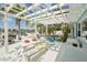 Spacious backyard patio features a large white pergola, dining area, and comfortable seating, ideal for entertaining at 6446 Lake Sunrise Dr, Apollo Beach, FL 33572
