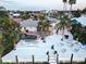 A stunning waterfront property with a beautiful pool, spacious deck, and lush tropical landscaping perfect for outdoor living at 6446 Lake Sunrise Dr, Apollo Beach, FL 33572