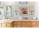 Bathroom with light wood cabinets, a vanity, and decorative artwork at 6446 Lake Sunrise Dr, Apollo Beach, FL 33572