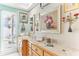 Bathroom boasts blonde wood vanity, decorative art, and a window for natural light at 6446 Lake Sunrise Dr, Apollo Beach, FL 33572