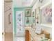 Bright bathroom with wood vanity, tile floor, shower, and decorative art at 6446 Lake Sunrise Dr, Apollo Beach, FL 33572