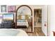 Bedroom features a bed reflected in large mirror and curated wall art at 6446 Lake Sunrise Dr, Apollo Beach, FL 33572