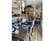 Elegant dining area with hardwood floors, fully set table, stylish chandelier and access to the kitchen at 6446 Lake Sunrise Dr, Apollo Beach, FL 33572