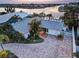 Aerial view of a beautiful waterfront home with lush tropical landscaping and a charming front yard at 6446 Lake Sunrise Dr, Apollo Beach, FL 33572