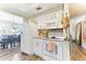 Bright kitchen features white cabinets, tile backsplash, and modern appliances at 6446 Lake Sunrise Dr, Apollo Beach, FL 33572