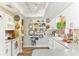 Bright kitchen featuring white cabinetry, modern appliances, and unique decorative plates on display at 6446 Lake Sunrise Dr, Apollo Beach, FL 33572