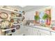 Bright kitchen featuring white cabinets, modern appliances, and decorative dishware and plants at 6446 Lake Sunrise Dr, Apollo Beach, FL 33572