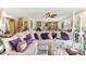 Bright living room with a large comfortable sofa, ceiling fan, artwork and windows at 6446 Lake Sunrise Dr, Apollo Beach, FL 33572