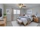Cozy bedroom with a wooden bed frame, neutral decor, and ambient lighting fixtures at 10116 Tulip N St # 10116, Pinellas Park, FL 33782