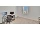 Bright bedroom with a desk setup near a window, showcasing a functional and modern space at 11827 Cara Field Ave, Riverview, FL 33579