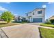 Inviting two-story home with blue garage door, showcasing curb appeal with lush green lawn and concrete driveway at 11827 Cara Field Ave, Riverview, FL 33579