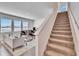 Open-concept living room with staircase, large windows and neutral color palette at 11827 Cara Field Ave, Riverview, FL 33579