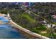 Stunning aerial view of waterfront property, a grassy park, sidewalks, and a vibrant city skyline in the background at 1200 N Shore Ne Dr # 204, St Petersburg, FL 33701