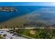 Picturesque aerial view showcases a pristine waterfront with clear blue waters, walking path, and lush green spaces at 1200 N Shore Ne Dr # 204, St Petersburg, FL 33701