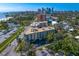 A high-angle view features a condo with parking, landscaping and a nearby tennis court at 1200 N Shore Ne Dr # 204, St Petersburg, FL 33701