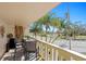 Outdoor balcony features a seating area, bamboo decor, and beautiful views of the neighborhood with tropical palm trees at 1200 N Shore Ne Dr # 204, St Petersburg, FL 33701
