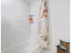 Bright bathroom featuring tiled walls and a tub, complemented by modern fixtures at 1200 N Shore Ne Dr # 204, St Petersburg, FL 33701