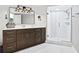 Updated bathroom with granite counters, dark wood cabinets, and a glass-enclosed shower at 1200 N Shore Ne Dr # 204, St Petersburg, FL 33701