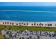 Scenic beach view with clear blue water, palm trees, and parking area at 1200 N Shore Ne Dr # 204, St Petersburg, FL 33701