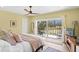 Cozy bedroom with a ceiling fan and sliding glass doors leading to a private balcony at 1200 N Shore Ne Dr # 204, St Petersburg, FL 33701