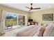 Bright bedroom with a ceiling fan, balcony access, and sliding glass doors for lots of light at 1200 N Shore Ne Dr # 204, St Petersburg, FL 33701