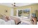 Comfortable bedroom with a ceiling fan and access to a patio with water views at 1200 N Shore Ne Dr # 204, St Petersburg, FL 33701