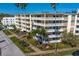 Multi-story condo building featuring private balconies, tropical landscaping, and a well-maintained lawn, in a vibrant community at 1200 N Shore Ne Dr # 204, St Petersburg, FL 33701