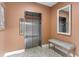 Modern stainless-steel elevator with adjacent seating and decorative mirror in a well-lit common area at 1200 N Shore Ne Dr # 204, St Petersburg, FL 33701
