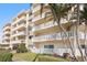 Exterior view showcasing pristine balconies with white railings and lush landscaping at 1200 N Shore Ne Dr # 204, St Petersburg, FL 33701