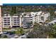 Exterior view showcases pristine balconies and mature palm trees at 1200 N Shore Ne Dr # 204, St Petersburg, FL 33701