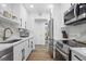 Modern kitchen with white cabinets, stainless steel appliances, and sleek countertops at 1200 N Shore Ne Dr # 204, St Petersburg, FL 33701