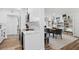 Open concept kitchen with white cabinets and stainless appliances, flowing into the dining area at 1200 N Shore Ne Dr # 204, St Petersburg, FL 33701