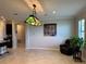 Bright living room with tile floors, a decorative light fixture and comfortable seating at 13359 Orca Sound Dr, Riverview, FL 33579