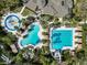 Aerial view of the community pool with lap lanes, a play pool, and lush landscaping at 4446 Wildstar Cir, Wesley Chapel, FL 33544