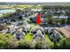Aerial view of the home and neighborhood with arrow pointing to subject property at 4446 Wildstar Cir, Wesley Chapel, FL 33544