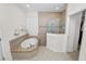 Bright bathroom boasting a soaking tub, a glass-enclosed shower, and neutral tiling at 4446 Wildstar Cir, Wesley Chapel, FL 33544