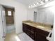 Spacious bathroom featuring double vanities, granite counters, and a separate shower tub combo at 4446 Wildstar Cir, Wesley Chapel, FL 33544
