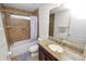 Bathroom with a single vanity, granite countertops and a shower-tub combo with tiled walls at 4446 Wildstar Cir, Wesley Chapel, FL 33544