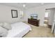Bedroom featuring carpet floors, ceiling fan, a large window and a dark wood dresser at 4446 Wildstar Cir, Wesley Chapel, FL 33544