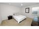 Cozy bedroom featuring carpet floors, a ceiling fan, and a large window at 4446 Wildstar Cir, Wesley Chapel, FL 33544