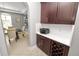 A sunlit dining area shows the kitchen’s dark wood cabinets, sleek countertops, and printer station at 4446 Wildstar Cir, Wesley Chapel, FL 33544