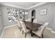 A formal dining room features elegant decor, a dark wood table, and seating for six at 4446 Wildstar Cir, Wesley Chapel, FL 33544