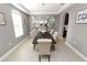 An elegant dining room showcases large windows, stylish decor, and seating for six at 4446 Wildstar Cir, Wesley Chapel, FL 33544