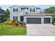 Beautiful two-story home featuring a well-manicured lawn and three-car garage at 4446 Wildstar Cir, Wesley Chapel, FL 33544