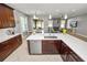 Open-concept kitchen showcasing a large island, dark cabinets, and stainless-steel appliances at 4446 Wildstar Cir, Wesley Chapel, FL 33544