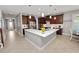 Spacious kitchen with dark wood cabinets, stainless steel appliances, and center island at 4446 Wildstar Cir, Wesley Chapel, FL 33544