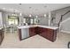 The kitchen features a central island with a sink and dishwasher and an open floor plan at 4446 Wildstar Cir, Wesley Chapel, FL 33544