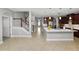 Spacious kitchen with a large island, stainless steel appliances, and view of the staircase at 4446 Wildstar Cir, Wesley Chapel, FL 33544