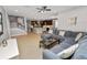 Open-concept living room with modern decor, tile floors, and a large sectional sofa at 4446 Wildstar Cir, Wesley Chapel, FL 33544